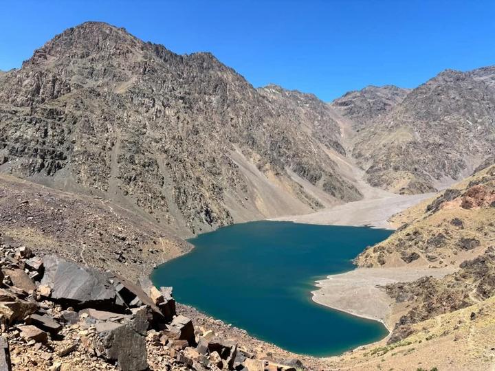 A blue mountain lake below rocky Atlas peaks